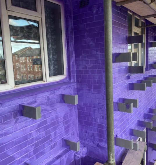 "Seamless airtight membrane applied to brick façade, ready for external insulation and cladding"