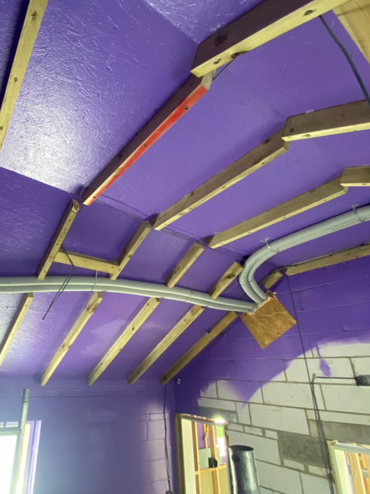 Installing Passive Purple airtight vapour control membrane on timber frame structure to improve energy efficiency and moisture management