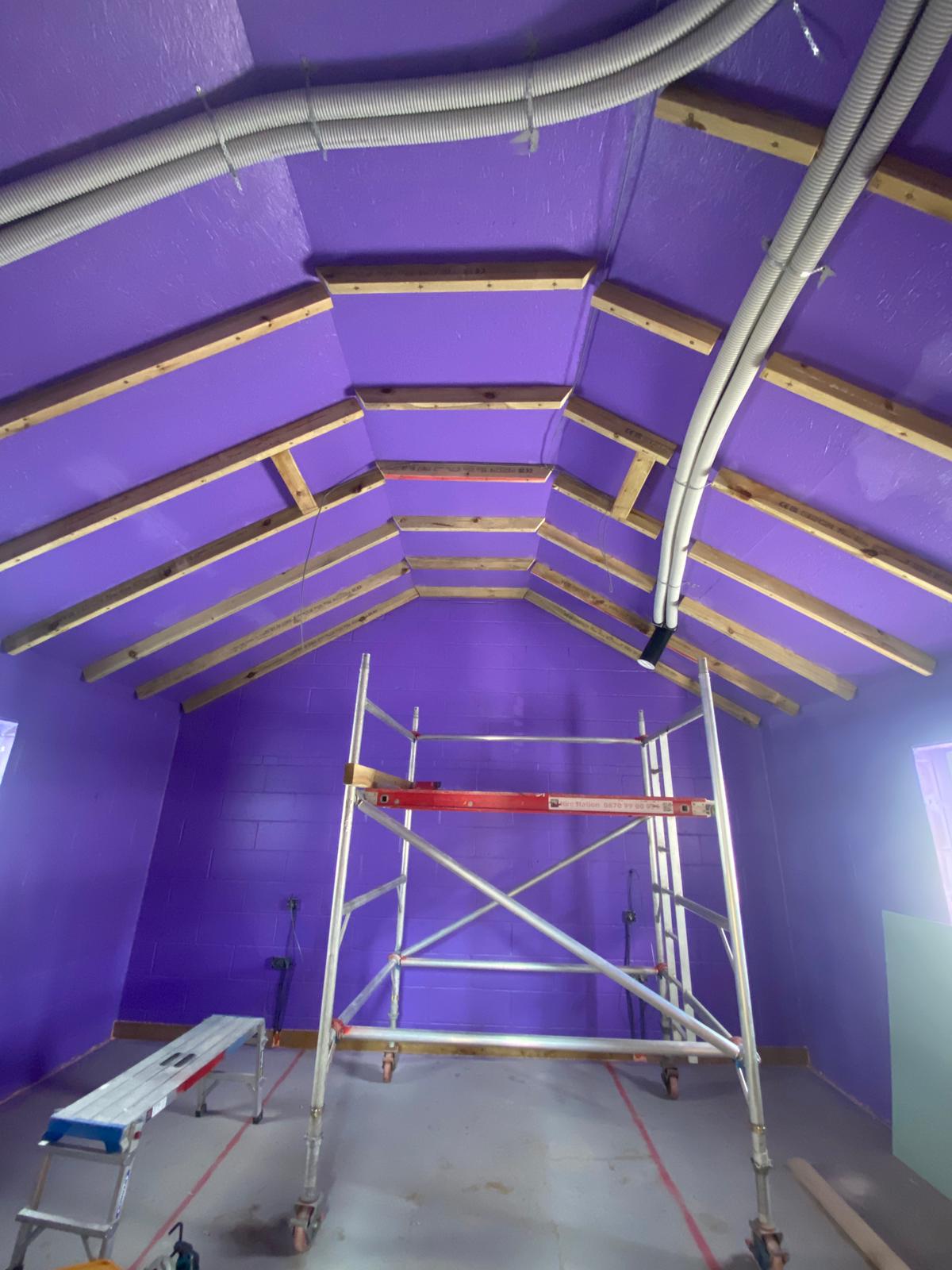 Applying Passive Purple airtight liquid membrane to internal walls on The Dairy Passive House project for superior airtightness and moisture control