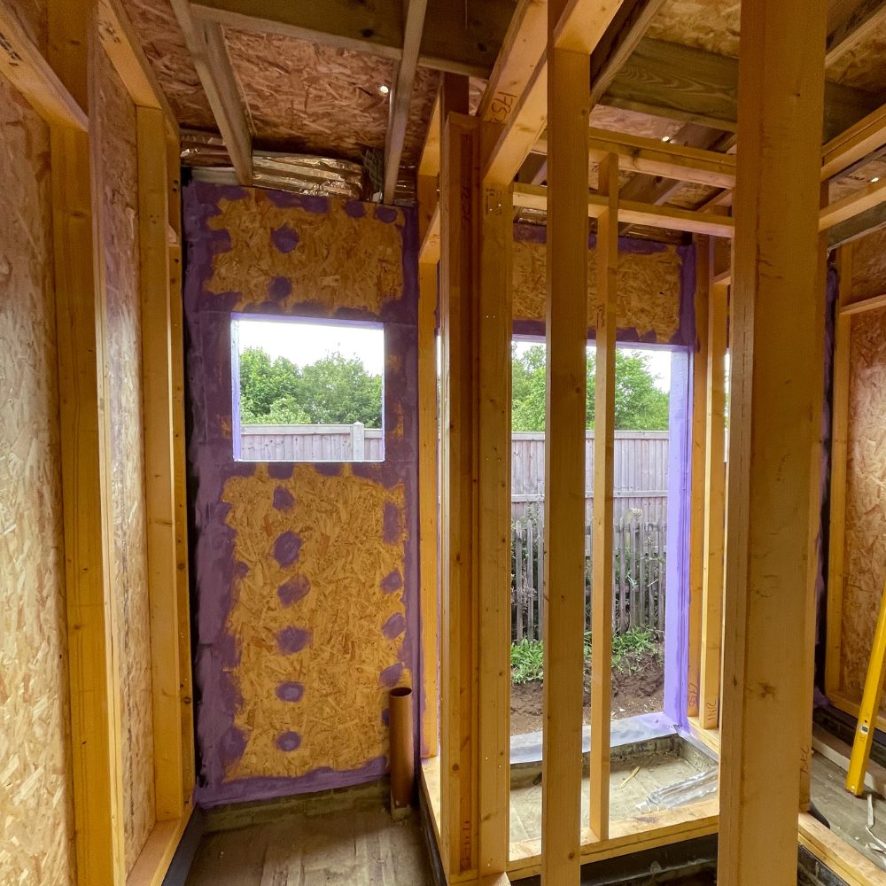 Installer applying Passive Purple Brush to OSB joints at Passivhaus standard school build for exceptional airtightness.