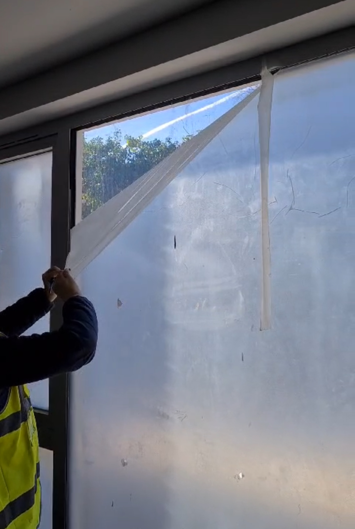 Spray-on window protection film applied to glass to prevent scratches, paint overspray, and damage during construction